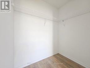 Guelph (Willow West/Sugarbush/West Acres) condo for rent - A white room with a wooden floor and a white wall.