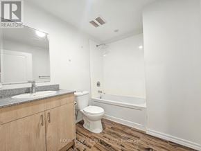 Guelph (Willow West/Sugarbush/West Acres) condo for rent - A white bathroom with a sink, toilet, and bathtub.