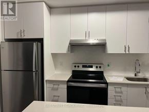 Oakville (Jm Joshua Meadows) condo for rent - A kitchen with a stainless steel refrigerator, oven, and sink.