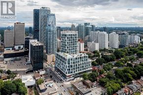 Toronto (Mount Pleasant West) condo for rent - A cityscape with a mix of modern and older buildings, with a clear sky above.