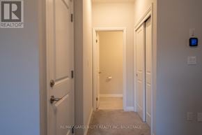 Niagara Falls (Cherrywood) house for rent - A hallway with a door on the left and a door on the right.