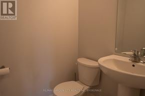 Niagara Falls (Cherrywood) house for rent - A white toilet sits next to a white sink in a bathroom.