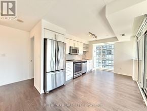 Toronto (Moss Park) condo for rent - A kitchen with a refrigerator, oven, and microwave.