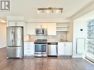 Toronto (Moss Park) condo for rent - A kitchen with white cabinets and stainless steel appliances.