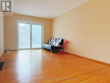 Toronto (Don Valley Village) apartment for rent - A living room with a sofa and a sliding glass door.