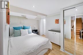Toronto (Birchcliffe-Cliffside) apartment for rent - A bedroom with a white bed and a wooden floor.