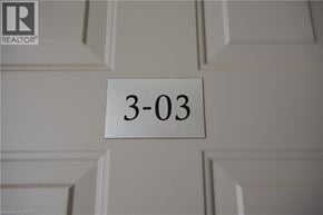 Oakville townhouse for rent - A white door with a sign that says 3-03 on it.