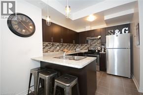 Oakville townhouse for rent - A kitchen with a marble countertop and a refrigerator.