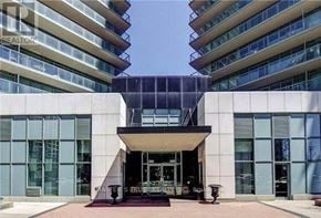 Toronto (Willowdale West) condo for rent - A modern building with a glass entrance and a sign that reads "Masters Trust.".