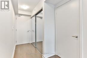 Toronto (Yonge-Eglinton) condo for rent - A white hallway with a glass door and a white door.