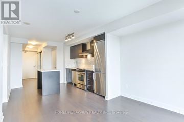 Toronto (Yonge-Eglinton) condo for rent - A spacious kitchen with stainless steel appliances and a refrigerator with a water dispenser.