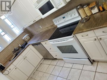 Toronto (Annex) multi-family for rent - A kitchen with a stove top oven and microwave.