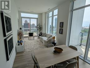 Toronto (Niagara) condo for rent - A modern living room with a view of the city.