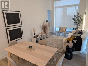 Toronto (Niagara) condo for rent - A modern living room with a wooden table and chairs.