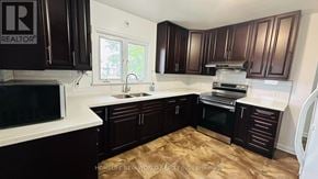 Belleville (Thurlow Ward) apartment for rent - A long hallway with a light on the ceiling and a sign on the floor.