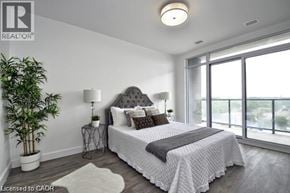 Cambridge condo for rent - A bedroom with a large bed and a potted plant.