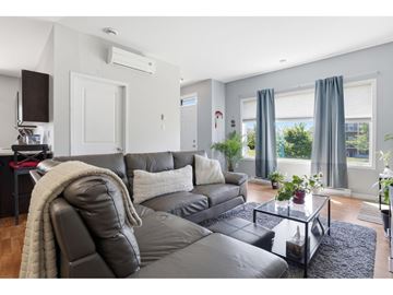 Gatineau (Aylmer) condo for rent - A modern living room with a grey sofa and a glass coffee table.