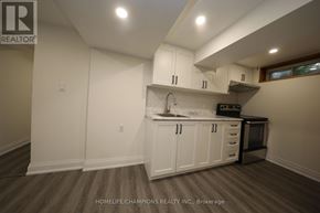 Toronto (Bendale) apartment for rent - A kitchen with white cabinets and a wooden floor.