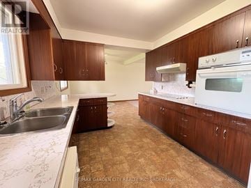 Pelham (Fonthill) apartment for rent - A kitchen with wooden cabinets and a white oven.