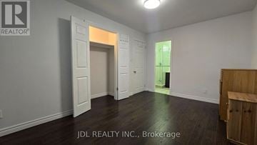 Markham (Grandview) apartment for rent - A room with a wooden floor and white walls, with a doorway leading to another room.