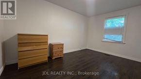 Markham (Grandview) apartment for rent - A room with a wooden dresser and a small table.