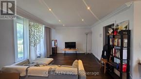 Markham (Grandview) apartment for rent - A living room with a couch, a television, and a bookshelf.