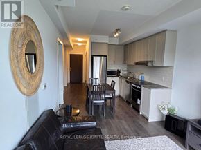 Markham (Unionville) condo for rent - A kitchen with a black couch and a mirror on the wall.