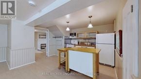 Richmond Hill (Crosby) apartment for rent - A kitchen with white appliances and wooden cabinets.