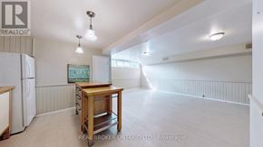 Richmond Hill (Crosby) apartment for rent - A realtor's office with a white fridge and a wooden table.