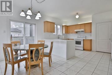 Markham (Cachet) apartment for rent - A kitchen with a table and chairs in front of a window.