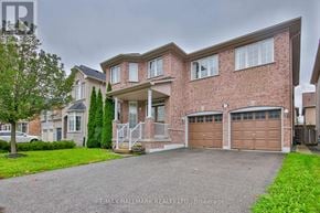 Markham (Cachet) apartment for rent - A large brick house with a driveway in front.