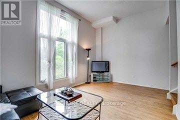 Markham (Bullock) townhouse for rent - A living room with a glass coffee table and a television.
