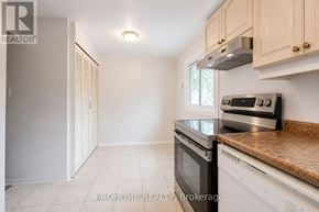 Markham (Bullock) townhouse for rent - A kitchen with a white oven and a microwave on the counter.