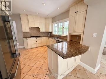 Oakville (Oo Old Oakville) apartment for rent - A kitchen with white cabinets and a granite countertop.