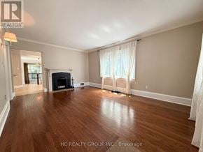 Oakville (Oo Old Oakville) apartment for rent - A spacious living room with hardwood floors and a fireplace.
