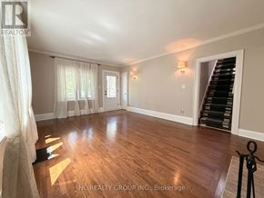 Oakville (Oo Old Oakville) apartment for rent - A spacious room with wooden flooring and a staircase on the right side.
