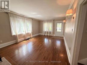 Oakville (Oo Old Oakville) apartment for rent - A room with wooden floors and white walls.