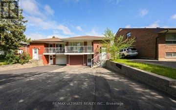 Mississauga (Erindale) apartment for rent - A red brick building with a white van parked in front.