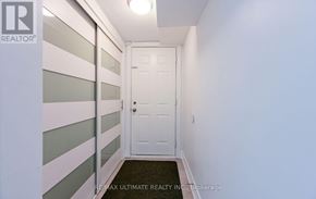 Mississauga (Erindale) apartment for rent - A hallway with a white door and a black doormat.