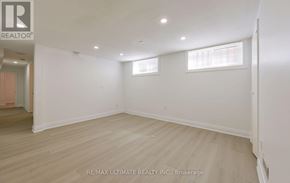Mississauga (Erindale) apartment for rent - A spacious room with wooden flooring and white walls.
