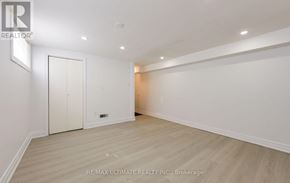 Mississauga (Erindale) apartment for rent - A spacious room with a white door and a wooden floor.