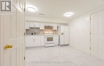 Mississauga (Erindale) apartment for rent - A white kitchen with a refrigerator, oven, and cabinets.