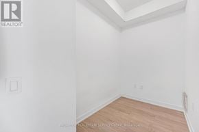 Mississauga (Hurontario) condo for rent - A white room with a wooden floor and a light switch on the wall.
