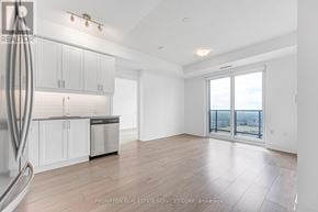 Mississauga (Hurontario) condo for rent - A spacious kitchen with white cabinets and a dishwasher in a room with a view.