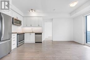 Mississauga (Hurontario) condo for rent - A kitchen with white cabinets and stainless steel appliances.
