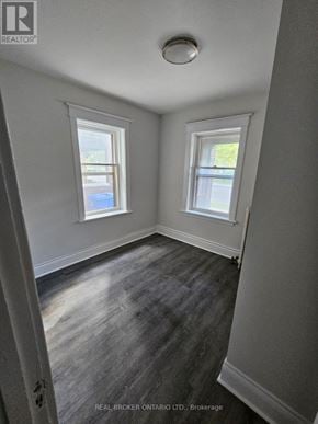 Hamilton (Crown Point) multi-family for rent - A room with two windows and a wooden floor.
