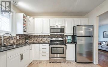 Haldimand apartment for rent - A kitchen with white cabinets and stainless steel appliances.