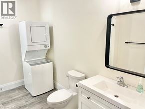 Simcoe apartment for rent - A white toilet with a cabinet above it in a bathroom.