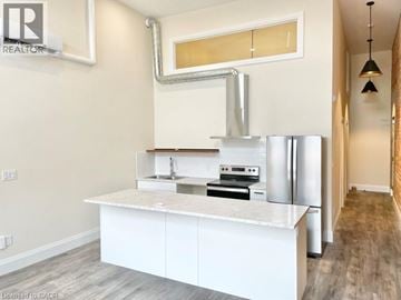 Simcoe apartment for rent - A modern kitchen with white cabinets and stainless steel appliances.