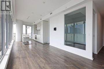 Toronto (Church-Yonge Corridor) condo for rent - A modern kitchen with white cabinets and a wooden floor.